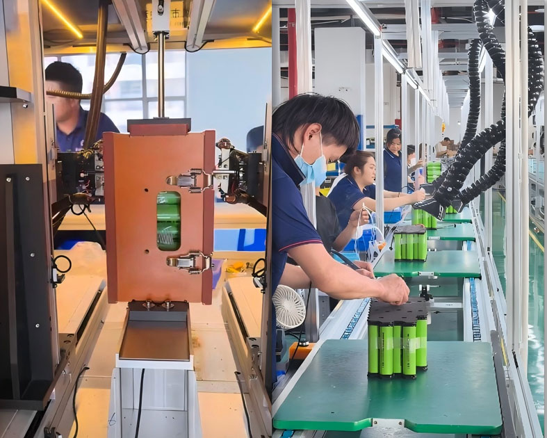 Technician qualityizing battery packs in laboratory